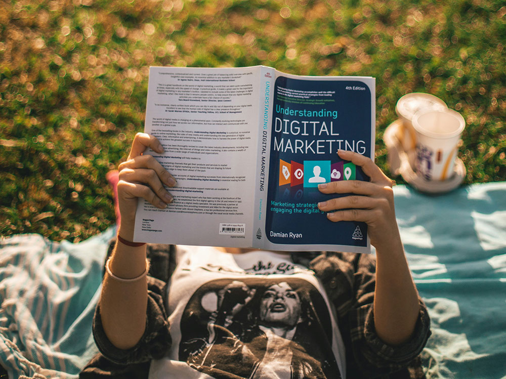 Person reading Digital Marketing brochure